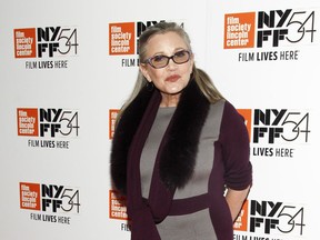 FILE - In this Monday, Oct. 10, 2016, file photo, actress Carrie Fisher attends a special screening of, "Bright Lights: Starring Carrie Fisher and Debbie Reynolds," at Alice Tully Hall in New York. J.J. Abrams says he will use unreleased footage of Fisher in the next "Star Wars" film to give the latest trilogy a "satisfying conclusion." Lucasfilm and writer-director Abrams announced Friday, July 27, 2018, that footage Fisher shot for 2015's "Star Wars: The Force Awakens" will be used in the ninth film in the space opera's core trilogies about the Skywalker family.