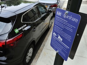 In this June 1, 2018 photo, an Enterprise CarShare vehicle occupies a parking space in one of the new designated Carshare areas, on New York's Upper West Side. New Yorkers are at odds over a new program that's taking away hundreds of public spaces and doling them out to companies that rent out cars by the hour.