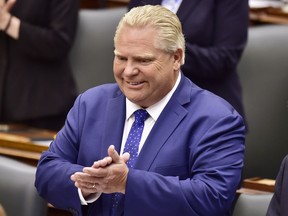 Ontario Premier Doug Ford applauds as Lt.-Gov. Elizabeth Dowdeswell delivers the speech from the throne to open the new legislative session at the Ontario Legislature at Queen's Park in Toronto on Thursday, June 12, 2018.