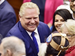 Ontario Premier Doug Ford, left, and his wife Karla greet attendees following the speech from the throne to open the new legislative session at the Ontario Legislature at Queen's Park in Toronto on Thursday, June 12, 2018.