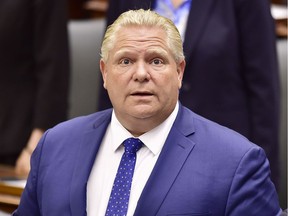 Ontario Premier Doug Ford applauds as Lt.-Gov. Elizabeth Dowdeswell delivers the speech from the throne to open the new legislative session at the Ontario Legislature at Queen's Park in Toronto on Thursday, June 12, 2018.