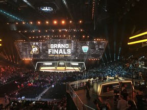 In this Friday, July 27, 2018, fans fill the arena as the stage is set for the Overwatch League Grand Finals' first night of competition, at the Barclays Center in the Brooklyn borough of New York. The Overwatch League is making a grand gamble: that its deep pockets and massive infrastructure can keep it atop the esports mountain even as Fortnite comes charging for the crown.
