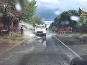 A white van appears to go out of its way to splash pedestrians in Ottawa.