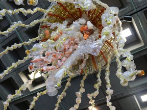 In this photo taken July 26, 2018, a giant jellyfish sculpture is viewed from below at the Audubon Aquarium of the Americas in New Orleans. The sculpture, made from fishing buoys and cut-up water bottles that washed up on the Pacific Coast, is among six placed around the aquarium.