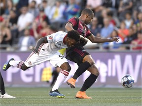 Toronto FC's Malik Johnson (56) battles with Ottawa Fury FC's Tony Taylor (99) during first half Canadian Championship soccer action in Ottawa on Wednesday, July 18, 2018.