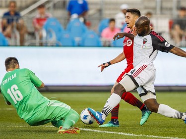 Ottawa Fury FC's Nana Attakora, right, and goalkeeper Maxime Crepeau, left, defend against Toronto FC's Marco Delgado, centre, during the first half of Canadian Championship soccer action in Toronto, Wednesday July 25, 2018.