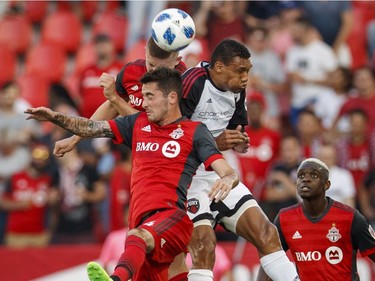 Toronto FC's Jay Chapman, left, battles for the ball with Ottawa Fury FC's Steevan Dos Santos during the first half of Canadian Championship soccer action in Toronto, Wednesday July 25, 2018.