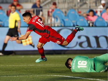 Toronto FC's Marco Delgado flies over Ottawa Fury FC's goalkeeper Maxime Crepeau during the first half of Canadian Championship soccer action in Toronto, Wednesday July 25, 2018.