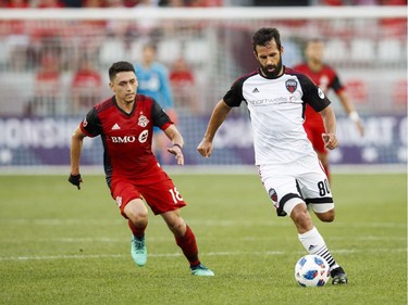 Ottawa Fury FC's Cristian Portilla battles for the ball with Toronto FC's Marco Delgado, left, during the first half of Canadian Championship soccer action in Toronto, Wednesday July 25, 2018.