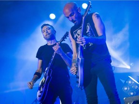 Lead singer Tim McIlrath, left, and Zach Blair from Chicago punk rock band Rise Against perform on the City Stage on the last night of RBC Ottawa Bluesfest on Sunday.