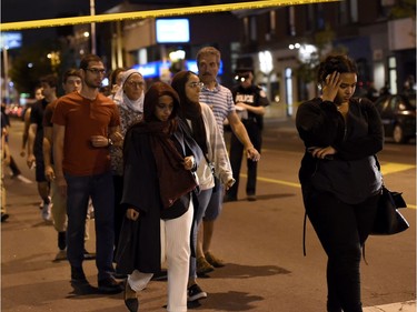 Civilians are escorted from the scene of a mass casualty incident in Toronto on Sunday, July 22, 2018.