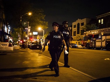 Police are seen securing a perimeter around a scene of mass casualty event in Toronto on Sunday, July 22, 2018.