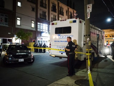 Police are seen securing a perimeter around a scene of mass casualty event in Toronto on Sunday, July 22, 2018.