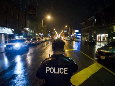 Police are seen around the scene of a shooting in east Toronto, on Monday, July 23, 2018.