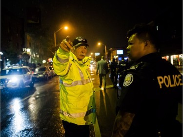 Police are seen around the scene of a shooting in east Toronto, on Monday, July 23, 2018.