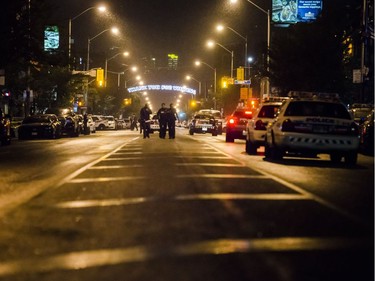 Police are seen around the scene of a shooting in east Toronto, on Monday, July 23, 2018.