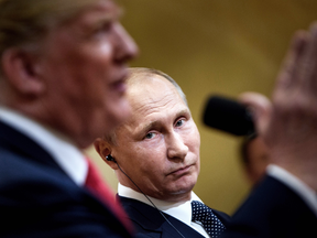 Russia's President Vladimir Putin listens while U.S. President Donald Trump speaks during a press conference in Helsinki, Finland, July 16, 2018.