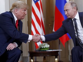 Why would anyone suspect collusion? U.S. President Donald Trump, left, and Russian President Vladimir Putin, right, shake hands at the beginning of a meeting at the Presidential Palace in Helsinki, Finland earlier this week.