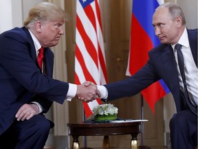 U.S. President Donald Trump, left, and Russian President Vladimir Putin, right, shake hands at the beginning of a meeting at the Presidential Palace in Helsinki, Finland earlier this week.