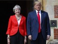 U.S. President Donald Trump with British Prime Minister Theresa May stand together at Chequers, in Buckinghamshire, England, Friday, July 13, 2018.