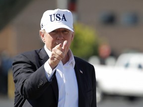 U.S. President Donald Trump points before boarding Air Force One at Morristown Municipal Airport, in Morristown, N.J., Sunday, July 8, 2018, en route to Washington from Trump National Golf Club in Bedminster, N.J.