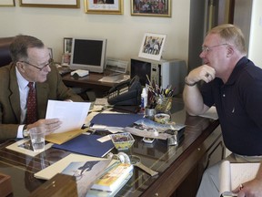 FILE - In this May 7, 2004, file photo, former President George H.W. Bush, left, talks about skydiving during an interview with Associated Press reporter Michael Graczyk, in Houston. Graczyk, who witnessed and chronicled more than 400 executions as a criminal justice reporter in Texas, will retire Tuesday, July 31, 2018, after 45 years.