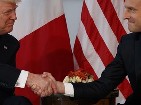 FILE - In this Thursday, May 25, 2017 file photo, U.S. President Donald Trump shakes hands with French President Emmanuel Macron during a meeting at the U.S. Embassy in Brussels. When Trump walks into a NATO summit Wednesday, July 11, 2018, international politics are bound to become intensely personal _ again.