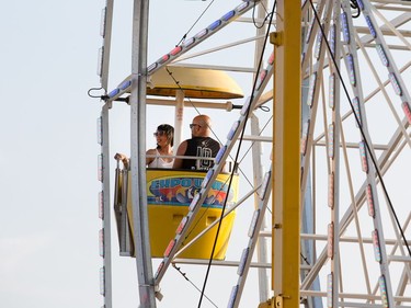 Music fans enjoy a turn on the ferris wheel as the RBC Bluesfest continues on the grounds of the Canadian War Museum at Lebreton Flats.