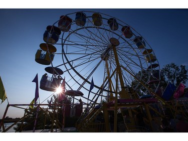 Music fans enjoy a turn on the ferris wheel as the RBC Bluesfest continues on the grounds of the Canadian War Museum at Lebreton Flats.