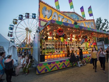 The Water Gun Fun booth and ferris wheel as the RBC Bluesfest continues on the grounds of the Canadian War Museum at Lebreton Flats.