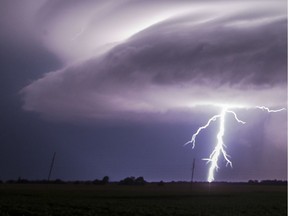 A lightning bolt emerges from a severe thunderstorm.