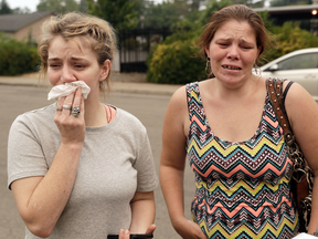 Sherry Bledsoe, left, cries next to her sister, Carla, outside of the sheriff's office after hearing news that Sherry's children, James and Emily, and grandmother, Melody Bledsoe, were killed in a wildfire Saturday, July 28, 2018, in Redding, Calif.