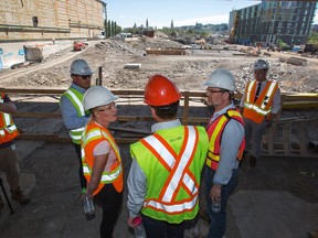 Ottawa Centre MP Catherine McKenna, (left), joins Gatineau Mayor Maxime Pedneaud-Jobin, right, and Jeff Westeinde of THEIA during Tuesday's tour of the Zibi site located near the Chaudière Falls.