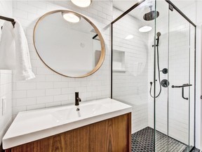 Black hexagon shower floor tiles and updated amenities give the new bathroom a modern edge. The homeowners say the black and white theme is something that will never go out of style.