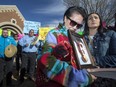 Colten Boushie's mother Debbie Baptiste, left, holds a photo of her son as his cousin Jade Tootoosis comforts her outside North Battleford provincial court at Gerald Stanley's preliminary hearing on Thursday, April 6, 2017. Stanley was eventually acquitted of second-degree murder in connection with Boushie’s death.