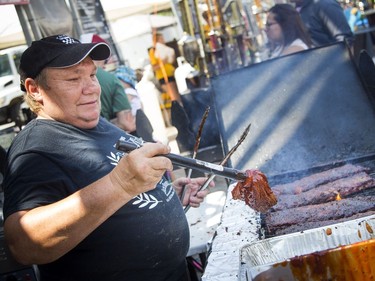 The smells of barbecue sauces wafted through the air in Festival Plaza at Ottawa City Hall during Capital Ribfest on Saturday, Aug. 4, 2018. All the way from Ohio, Harry Marburger sauces up some ribs at Jack on the Bone's spot.