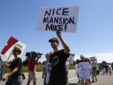 Members of the Hamilton Tenants Solidarity Network and the Herongate Tenant Coalition protest near the home of CLV Group CEO Mike McGahan in Manotick on Saturday, Aug. 11, 2018.