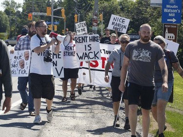 Members of the Hamilton Tenants Solidarity Network and the Herongate Tenant Coalition protest near the home of CLV Group CEO Mike McGahan in Manotick on Saturday, Aug. 11, 2018.