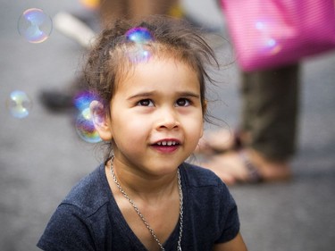 The FUSE Street Festival took over Westboro Saturday August 18, 2018 with music, buskers, shops and patios to stop and enjoy a meal at, to name a few. The festival is in support of Cornerstone Housing for Women and Westboro Region Food Bank shut down Richmond Road. Two-year-old Paris McMullan Albes enjoyed the bubbles blowing in the air.