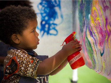 House of PainT festival took place Saturday August 25, 2018 under the Dunbar Bridge. Two and a half-year-old Akiba Atangana works on his artistic skills Saturday afternoon.