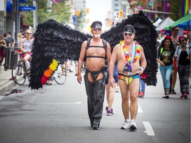 Doug Warren, left, of Toronto and Paul Clulow from Guelph made the trip to Ottawa to take in the Capital Pride Parade and other Pride weekend celebrations.  Ashley Fraser/Postmedia