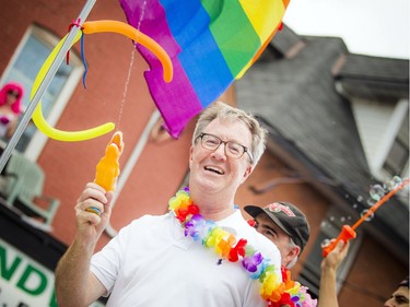 Ottawa Mayor Jim Watson was on the City of Ottawa float for Sunday's Capital Pride Parade with a water gun.   Ashley Fraser/Postmedia