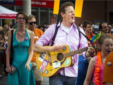 Ottawa Centre NDP MPP Joel Harden took part in the Capital Pride Parade on Sunday while playing his guitar and singing.   Ashley Fraser/Postmedia