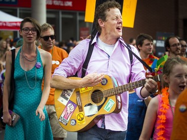 The Capital Pride Parade filled the streets with over 130 groups including community groups, sports teams, embassies and local businesses  along with thousands of spectators Sunday August 26, 2018. NDP Joel Harden of the Ottawa Centre riding took part in the march Sunday while playing his guitar and singing.   Ashley Fraser/Postmedia