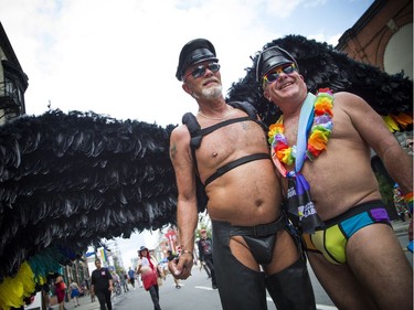 The Capital Pride Parade filled the streets with over 130 groups including community groups, sports teams, embassies and local businesses  along with thousands of spectators Sunday August 26, 2018. L-R Doug Warren of Toronto and Paul Clulow from Guelph made the trip to Ottawa to take in the Pride celebrations.  Ashley Fraser/Postmedia