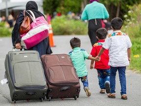 Asylum seekers walk along Roxham Road near Champlain, New York, making their way towards the Canada/US border.