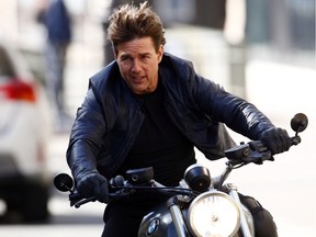 Tom Cruise rides a motorcycle.