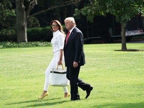 Melania Trump walks with U.S. President Donald Trump towards the Marine One helicopter on the South Lawn of the White House on July 27.