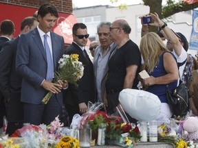 Canadian Prime Minister Justin Trudeau arrives to lay flowers in memory of Toronto shooting victims at a memorial on Danforth Ave., on July 30, 2018 in Toronto.