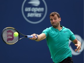 TORONTO, ON - AUGUST 09:  Grigor Dimitrov of Bulgaria plays a shot against Frances Tiafoe of the United States during a 3rd round match on Day 4 of the Rogers Cup at Aviva Centre on August 9, 2018 in Toronto, Canada.